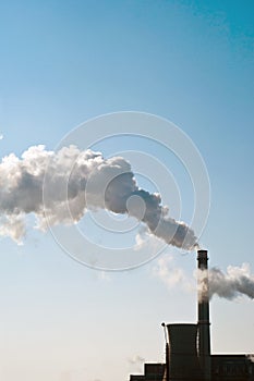 Industrial chimneys with heavy smoke causing air pollution