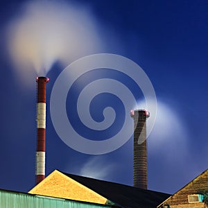 Industrial chimneys at night