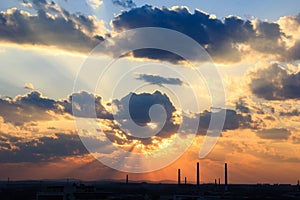 Industrial city silhouette against the sky on a sunset.