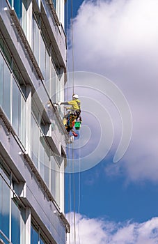 Industrial cleaners on the skyscraper surface