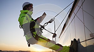 Industrial climber checks indicators via special tablet