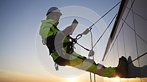 Industrial climber checks indicators via special tablet