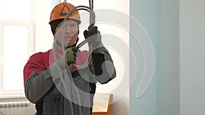 Industrial climber knits a rope for lifting equipment. a worker in a protective helmet knits a knot on a rope. photo