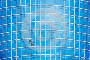 Industrial climber on the modern business centre wall