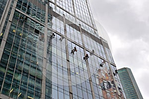 Industrial climber washes glass on the facade of a skyscraper