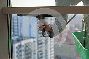 Industrial climber washes windows in the apartment