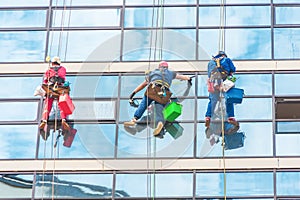 Industrial climbers cleaning the exterior facade of the rear glass of a skyscraper
