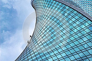 Industrial climbers on the wall of the Evolution skyscraper in Moscow city