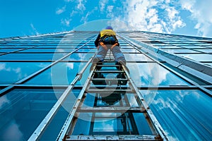 A industrial climbing worker washing windows