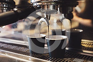 Industrial coffee machine making two cups of espresso