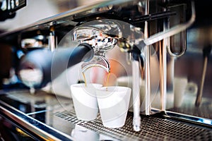 Industrial coffee maker preparing fresh espresso at pub