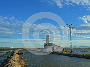 Industrial complex located on the edge of a river, with electrical power lines