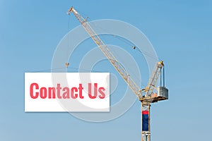 Industrial Construction crane holding a billboard