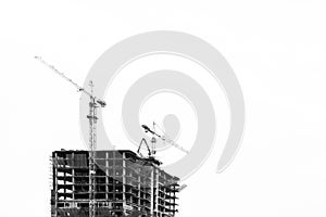 Industrial construction cranes and building black and white insolated.Industrial construction crane over building site