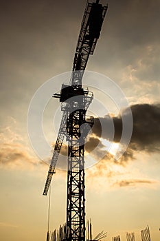 Industrial construction cranes and building silhouettes