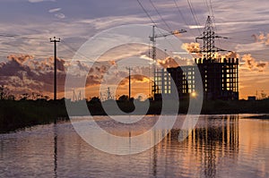 Industrial construction cranes and building silhouettes