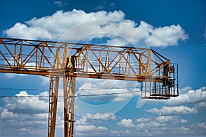 Industrial construction cranes and building silhouettes over sun at sunrise