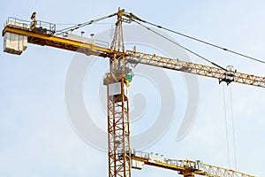 Industrial construction cranes and building. Working construction crane tower on the clear sky
