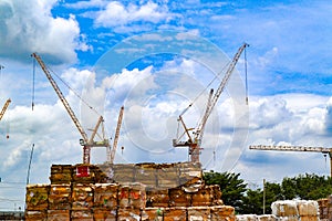 Industrial construction cranes and condominium building on the blue sky