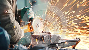 Industrial. Construction site. The man worker grinding. Fire sparkles