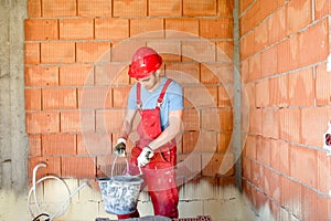 Industrial construction worker, builder, working on construction site.