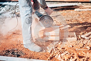 Industrial construction worker using a professional angle grinder
