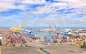 Industrial Container Cargo freight ship with working crane bridge in shipyard at dusk for Logistic Import Export background