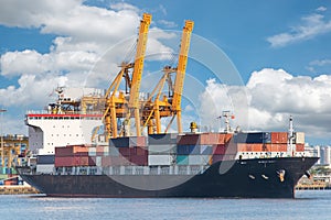 Industrial Container Cargo freight ship with working crane in sh