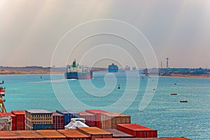 Industrial container ship passing through Suez Canal with ship's