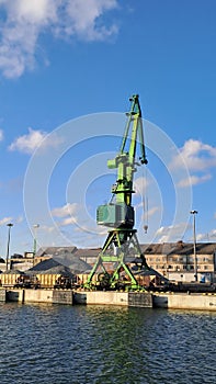 Industrial crane in the harbour. Train wagons, cargo