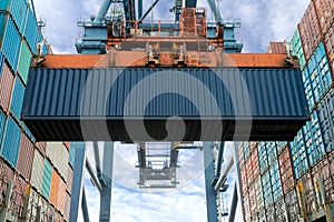 Industrial crane loading Containers in a Cargo freight ship. Con