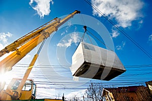 Industrial Crane operating and lifting an electric generator