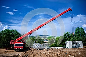 Industrial Crane operating and lifting an electric generator
