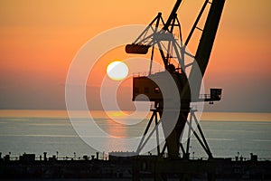 Industrial crane at sunrise