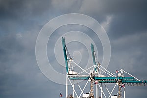 Industrial cranes on dramatic sky