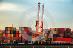 Industrial cranes loading freight containers for cargo ships.