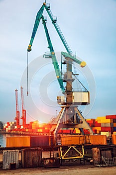 Industrial cranes loading freight containers for cargo ships.