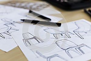Industrial design chair sketches with pens and drawing instruments