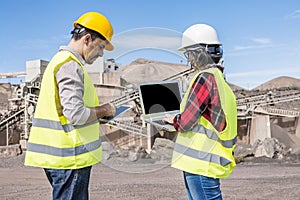 Industrial developers working with gadgets on construction site photo