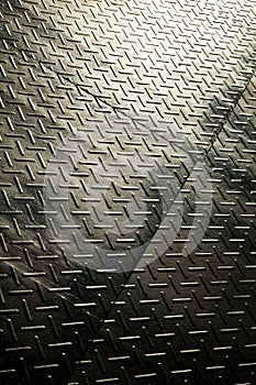 Industrial Diamond Plate Metal Texture with Light and Shadow Play Close-Up