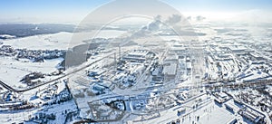Industrial district in winter. factory buildings, warehouses and thermal power plant on a cold winter day. aerial