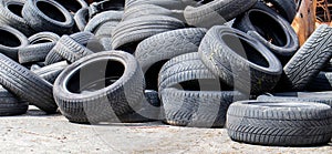 Industrial dump for the processing of used tires and rubber tires. Pile of old tires and wheels for rubber recycling