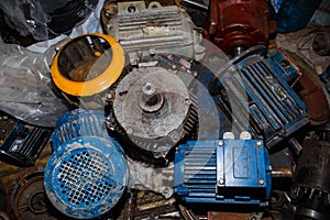 Industrial electric motors in a garage on a rack. Electrical equipment under repair, dirty asynchronous current generators