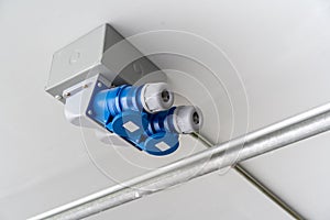 Industrial electric power safety plugs installed on white ceiling