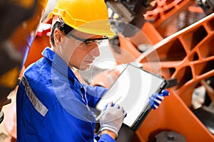 Industrial engineer foreman with hard working at industrial plant