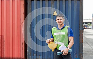 Industrial engineer holding hard hat with containers box background, Dock worker man holding clipboard checklist at containers