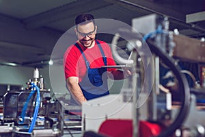 Industrial engineer with laptop in a  industrial manufacture factory working.