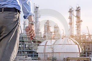 Industrial engineer stand in field of petrochem plant with the w