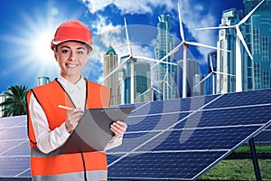 Industrial engineer in uniform and view of solar panels and wind energy turbines installed outdoors