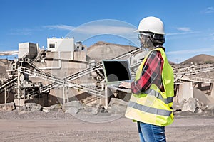 Industrial engineer using laptop on construction site photo